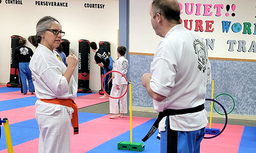 An adult Rouleau-Holley's Martial Arts student gets instruction during class