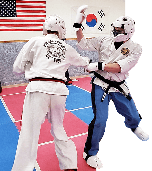Two Rouleau-Holley's Tae Kwon Do students sparring during training